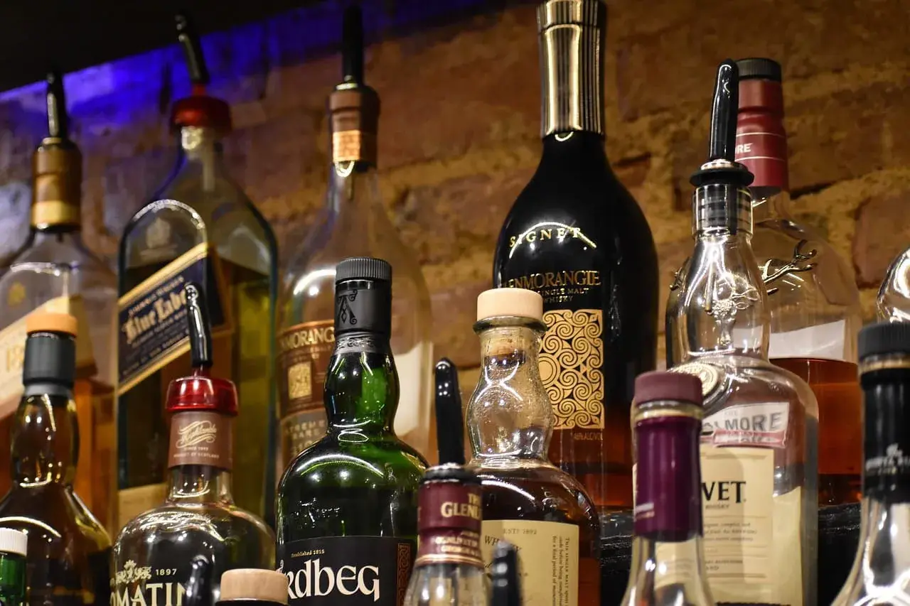 Butelki whisky na półce. Pionowe przechowywanie zapobiega objawy wyschnięcia korka.